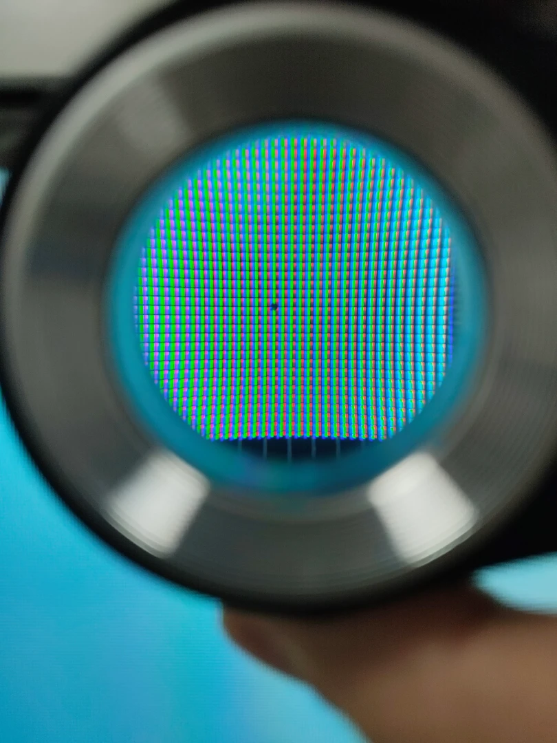 Dark dot defects on a liquid crystal display, with a pure white display pattern background.
