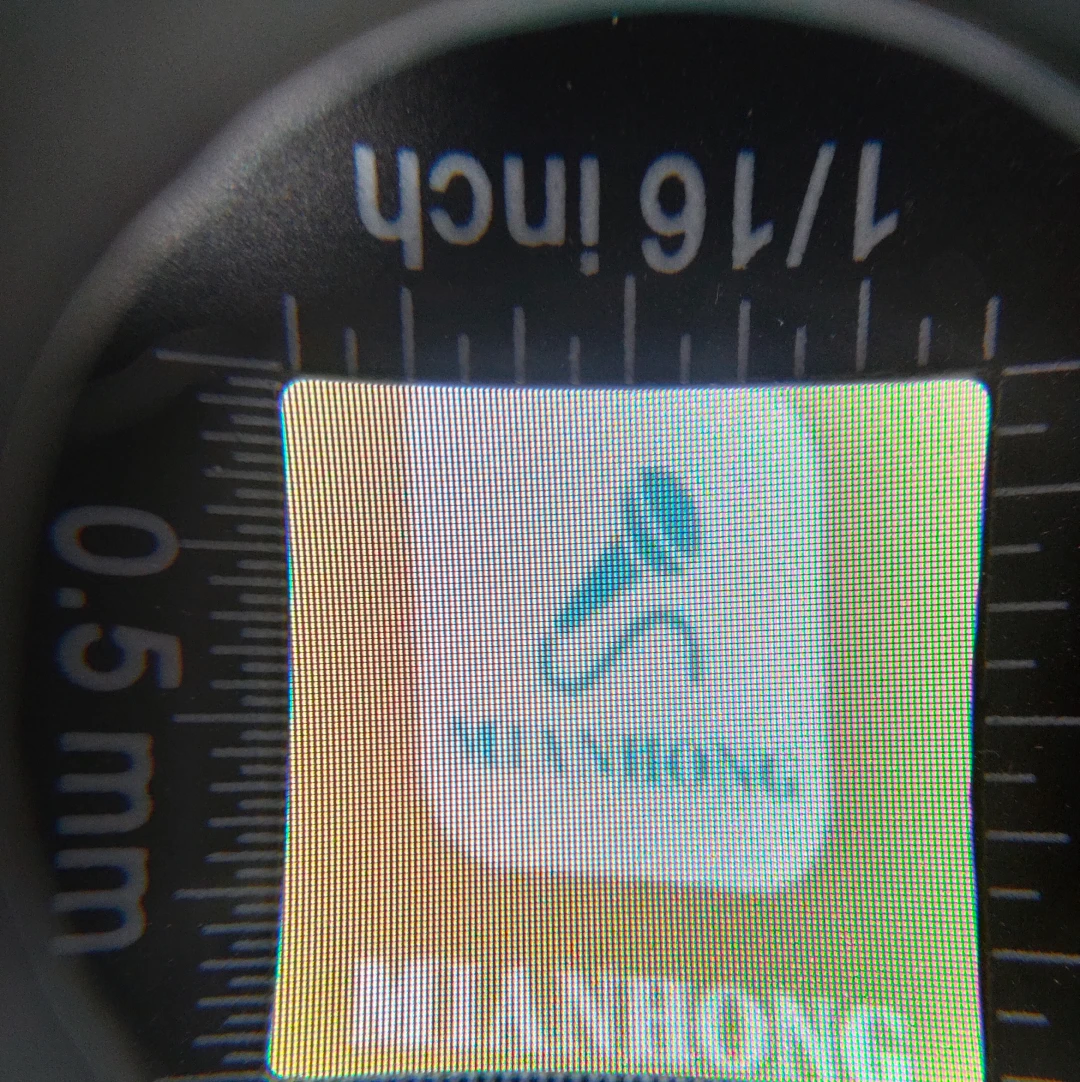 An image magnified on a television screen using a magnifying glass, intended to show that a pattern is made up of many individual pixels.